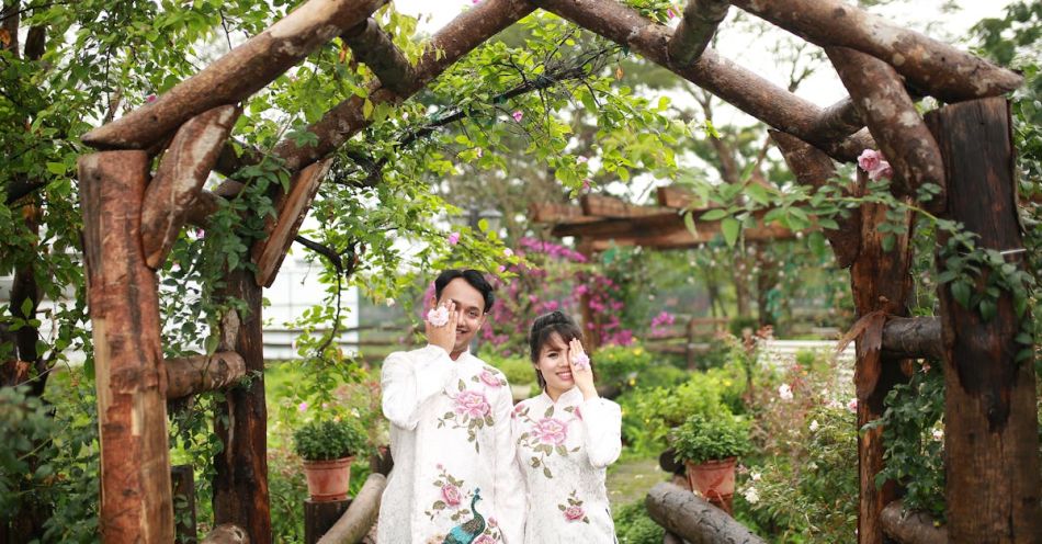 Pergola - Two people standing in front of a wooden arch