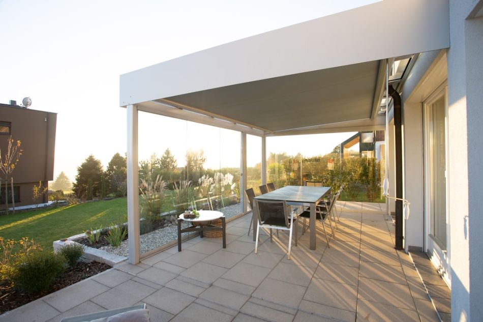 Pergola - black metal table and chairs on green grass field during daytime