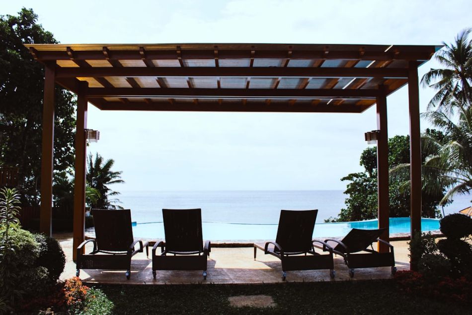 Pergola - photo of four loungers under gazebo facing swimming pool